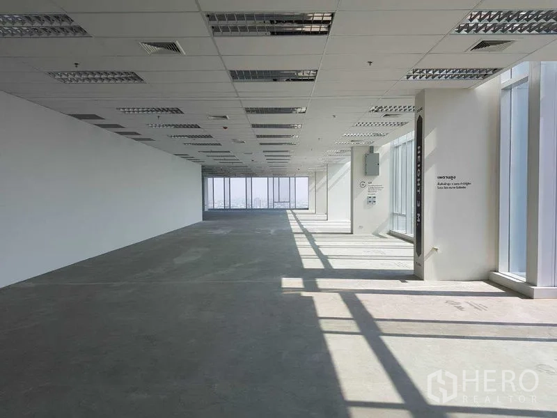 Office Space for rent - Spacious unfurnished office plate with abundant natural light streaming through full-height glazing.