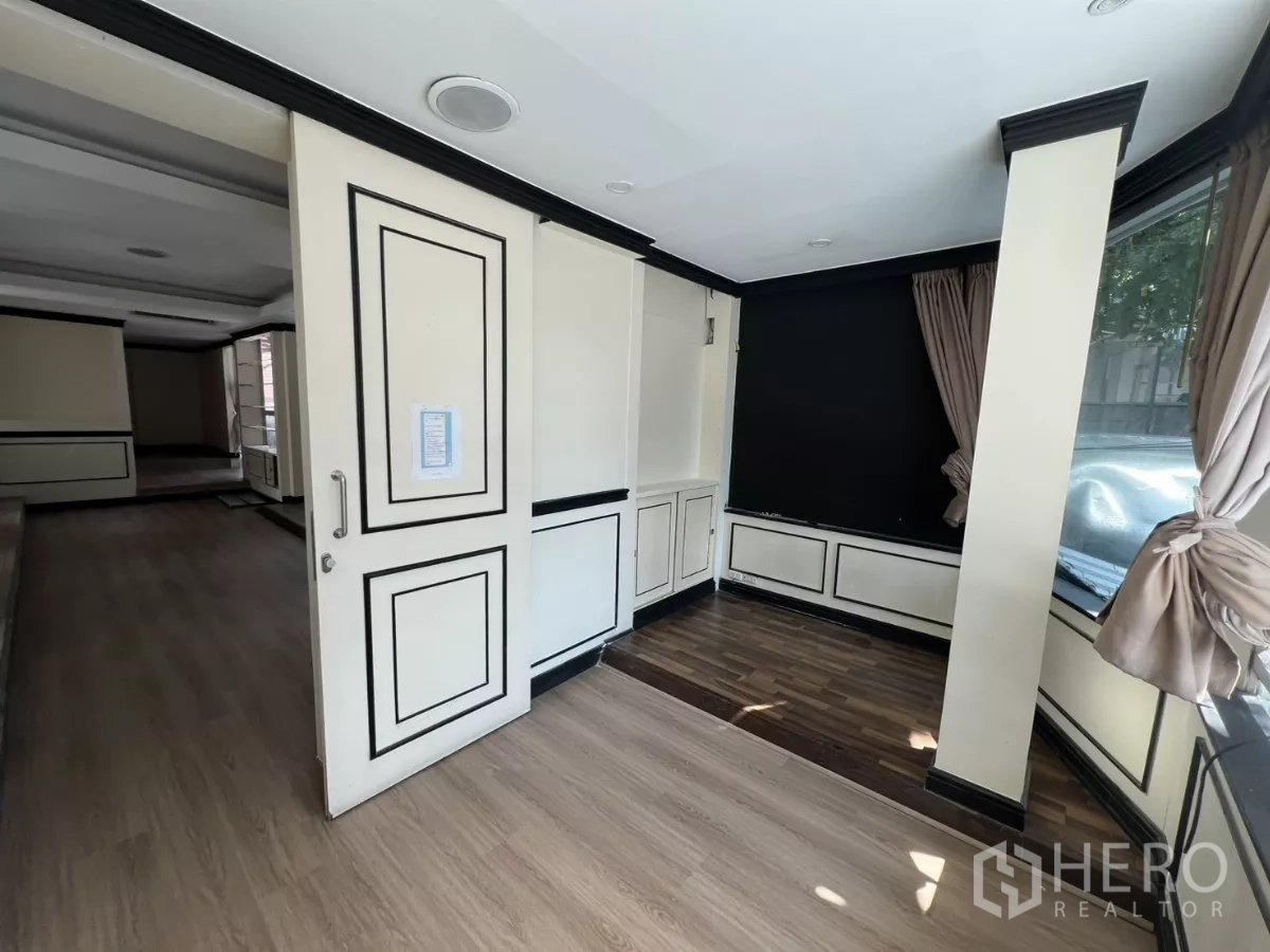 Retail Space for rent - Corner display bay with large street‑facing window and wood flooring.