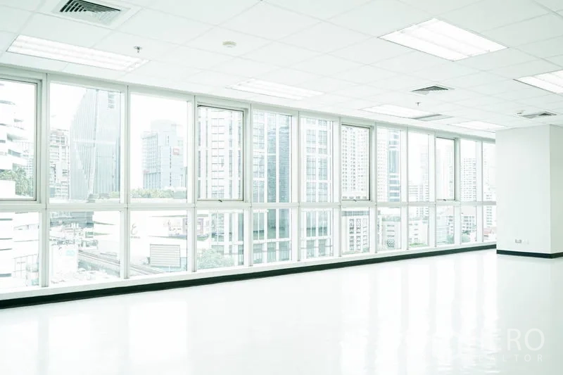 Office Space for rent in Watthana, Bangkok - Bright corner office with floor-to-ceiling windows and Bangkok skyline views.