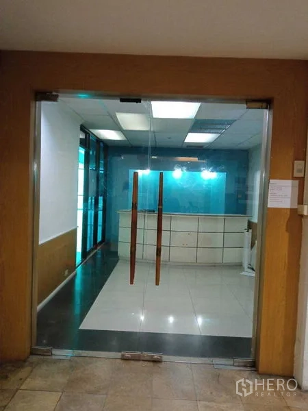 Office Space for rent in Huai Khwang, Bangkok - Reception area with double glass doors and front desk inside an office building.