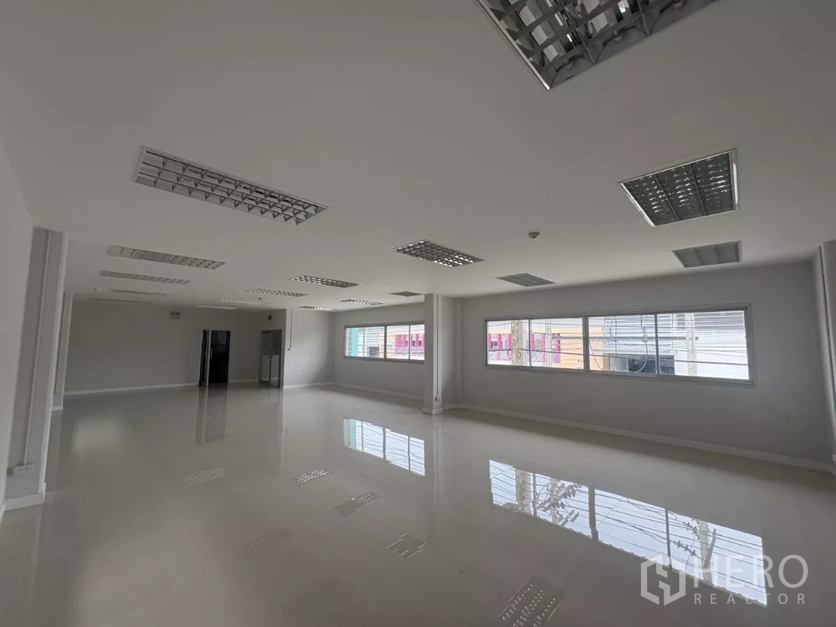 Factory for rent in Bang Phli, Samut Prakan - Large office room with wide windows and polished floors for administrative use.