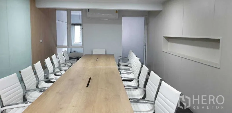 Home Office for rent or sale in Suan Luang, Bangkok - Bright meeting room with a long wood table and white chairs.