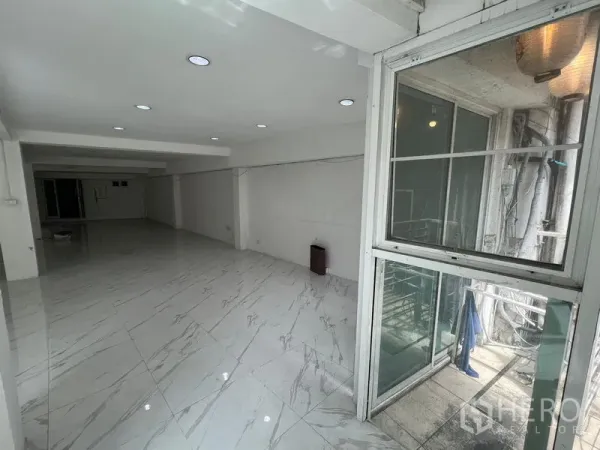 Retail Space for rent in Khlong Toei, Bangkok - Retail space with spotlight ceiling, sliding windows and a small service balcony outside.