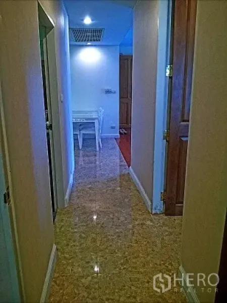 Condominium for rent in Pathum Wan, Bangkok - Bright hallway with polished tile floor leading to the dining area in a Bangkok condo.