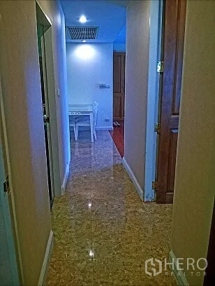 Condominium for rent in Pathum Wan, Bangkok - Bright hallway with polished tile floor leading to the dining area in a Bangkok condo.
