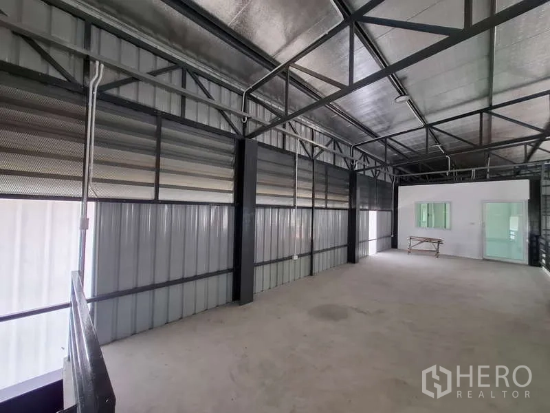 Warehouse for rent or sale in Bang Phli, Samut Prakan - Mezzanine storage zone with metal cladding and exposed services.