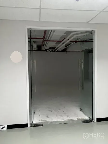 Office Space for rent - Glass double-door entrance leading from the corridor into the office unit.