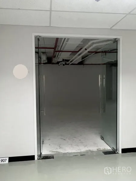 Office Space for rent - Glass double-door entrance leading from the corridor into the office unit.