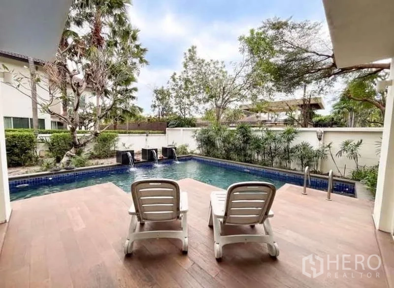 Detached House for rent in Bang Phli, Samut Prakan - Poolside deck with two sun loungers facing a walled garden and decorative fountain spouts.