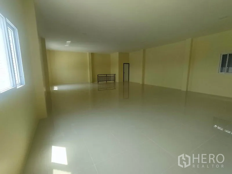 Factory for sale in Mueang Samut Sakhon, Samut Sakhon - Open-plan upper floor office with windows, railing and polished tile flooring.