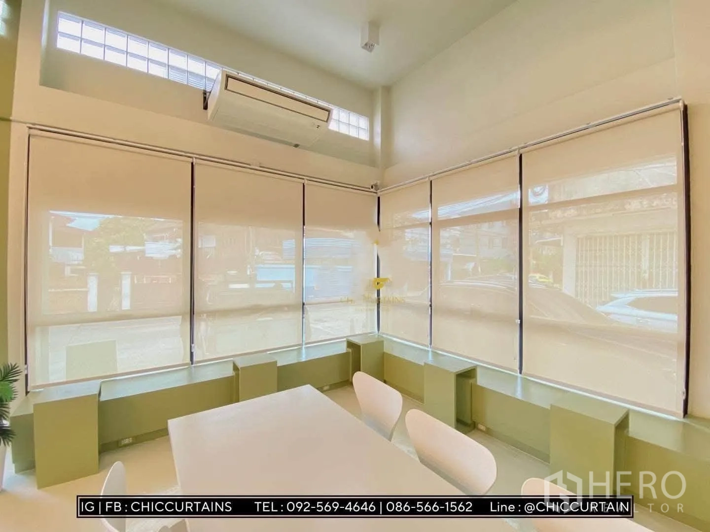 Shophouse for rent in Phra Khanong, Bangkok - Bright corner space with large windows, roller blinds, air conditioner, and meeting table with chairs.