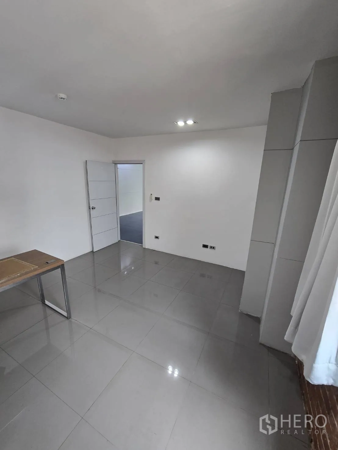 Office Space for rent in Watthana, Bangkok - Enclosed room with glossy gray tiles, white walls, and recessed lighting for meeting or private office.