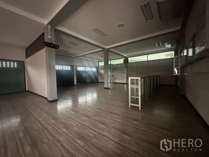 Standalone for rent in Prawet, Bangkok - Multipurpose room with shelves and display cabinets on tiled flooring.