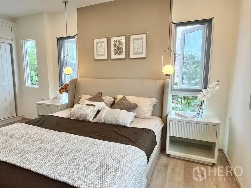 Detached House for rent - Master bedroom with upholstered bed, pendant lights, bedside tables and tall windows.