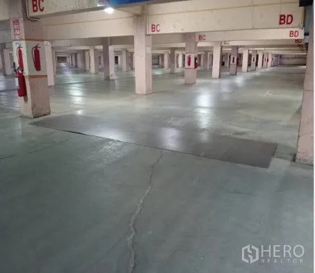 Warehouse for rent in Mueang Pathum Thani, Pathum Thani - Covered parking or staging zone with reinforced floor and safety markings.