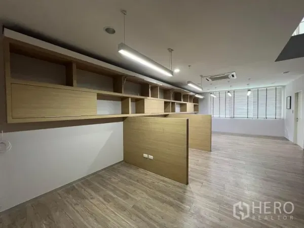 Home Office for rent in Bueng Kum, Bangkok - Workspace with built-in wood shelves, partition desks and LED strip lighting.