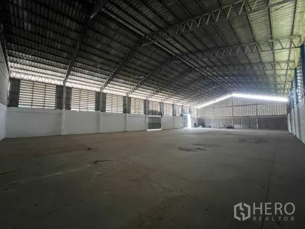 Warehouse for rent in Bang Pa-in, Phra Nakhon Si Ayutthaya - Open storage hall with steel trusses, ventilated walls and solid concrete flooring.