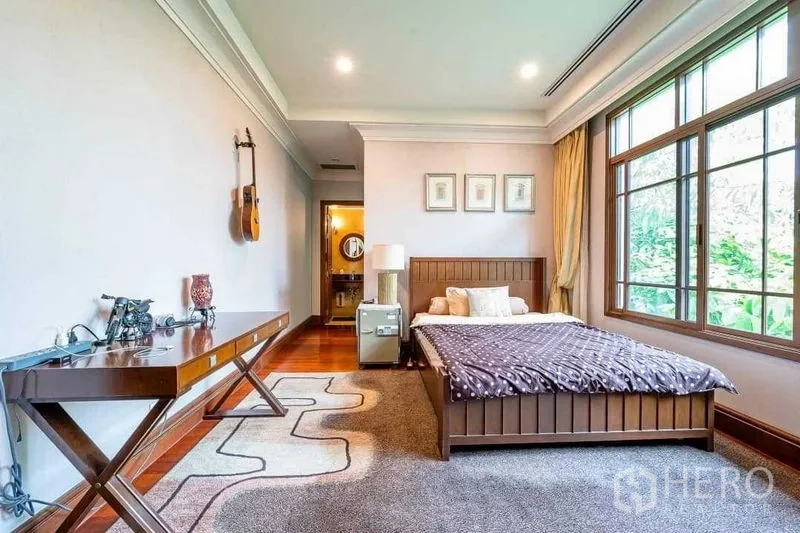 Detached House for sale - Bedroom with en-suite entrance, large window and wall-mounted guitars.