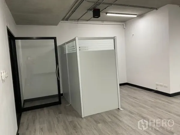 Office Space for rent - Glass entry door and modular partition creating a meeting room within the office space.