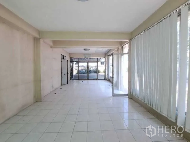 Retail Space for rent in Sathon, Bangkok - Ground-floor hall with glass storefront, vertical blinds, and tiled flooring.