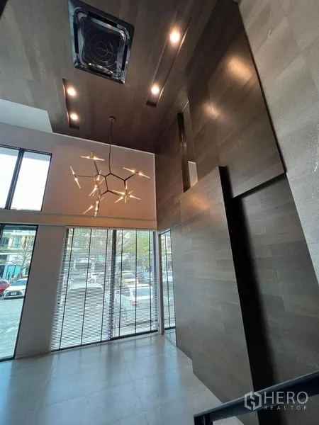 Home Office for rent in Bueng Kum, Bangkok - Tall street-facing lobby with full-height windows and designer chandelier.