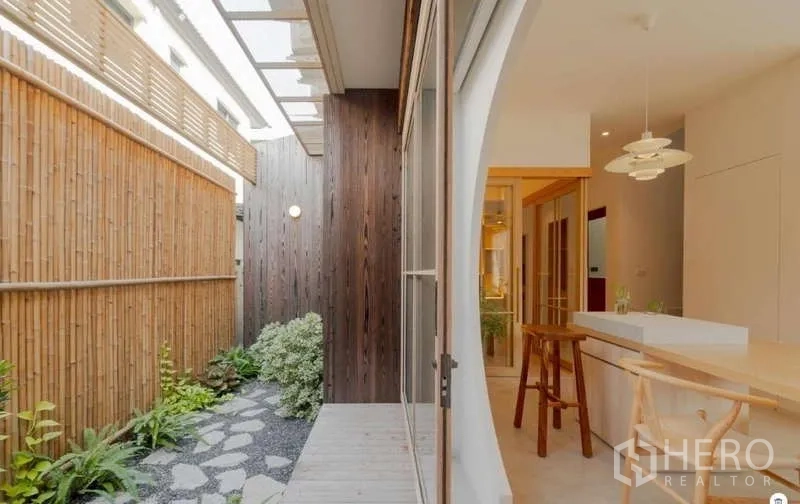 Detached House for sale in Bang Phli, Samut Prakan - Covered side courtyard with bamboo fence, stepping-stone path, and sliding glass doors to the kitchen.