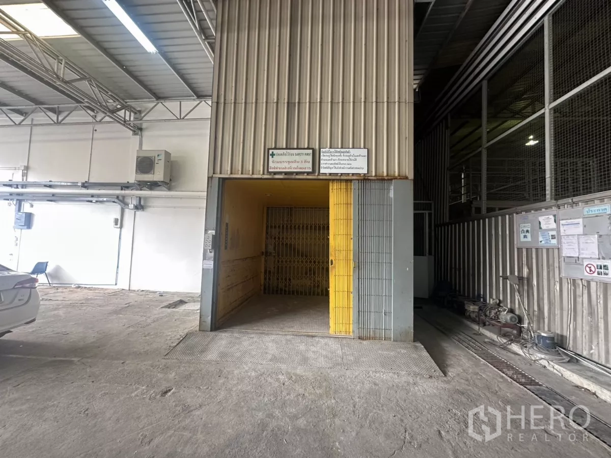 Warehouse for rent in Yan Nawa, Bangkok - Service lift with sliding safety gate inside the warehouse for moving goods between levels.
