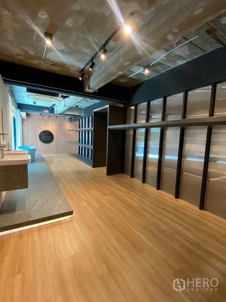 Home Office for rent in Wang Thonglang, Bangkok - Large open workspace with long shelving wall, raised platform and industrial ceiling