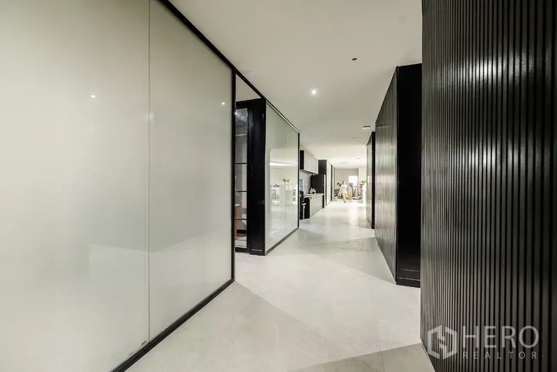 Office Space for rent or sale in Huai Khwang, Bangkok - Wide corridor with sliding frosted glass walls and recessed lighting.