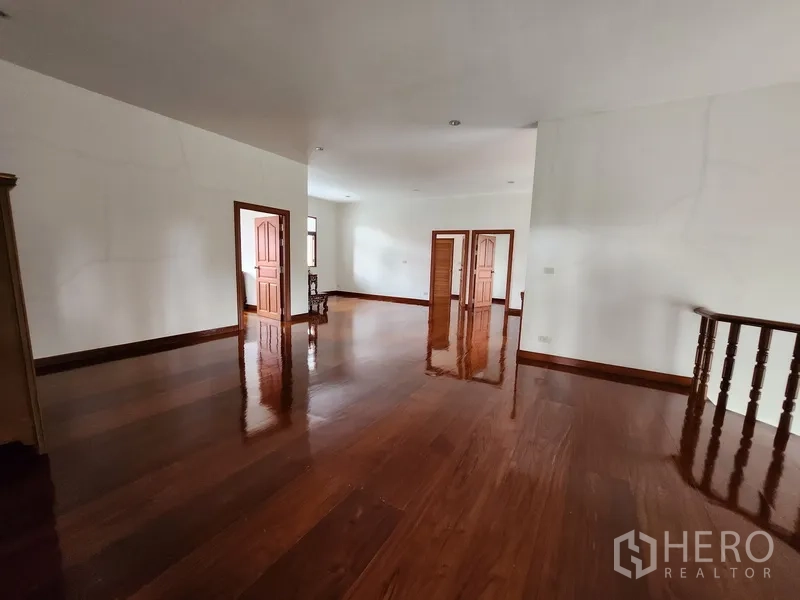 Detached House for rent in Prawet, Bangkok - Spacious upper landing with polished timber floors and multiple doorways.