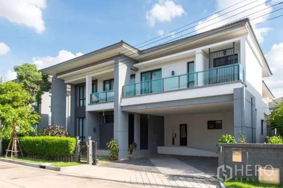 Detached House for rent or sale in Kanchanaburi - Front elevation of a luxury detached house featuring a wide balcony and gated garden.