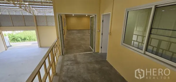 Warehouse for rent in Lat Krabang, Bangkok - Walkway to the mezzanine offices with railings overlooking the warehouse floor.