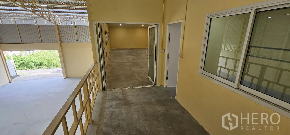Warehouse for rent in Lat Krabang, Bangkok - Walkway to the mezzanine offices with railings overlooking the warehouse floor.