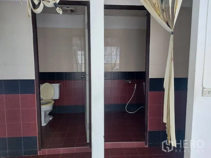 Office Space for rent in Pathum Wan, Bangkok - Private office restrooms with tiled floors, separated stalls, and handheld bidet sprayers.