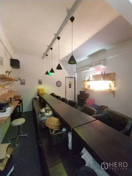 Shophouse for rent in Khlong Toei, Bangkok - Rear view of the bar with service counter, pendant lamps and shelving.