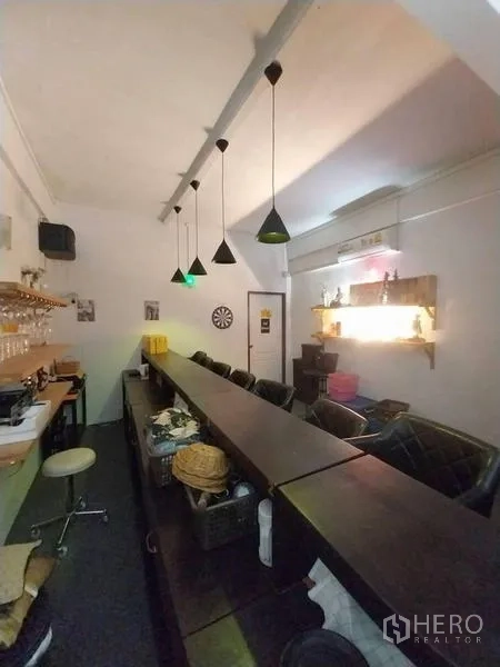 Shophouse for rent in Khlong Toei, Bangkok - Rear view of the bar with service counter, pendant lamps and shelving.