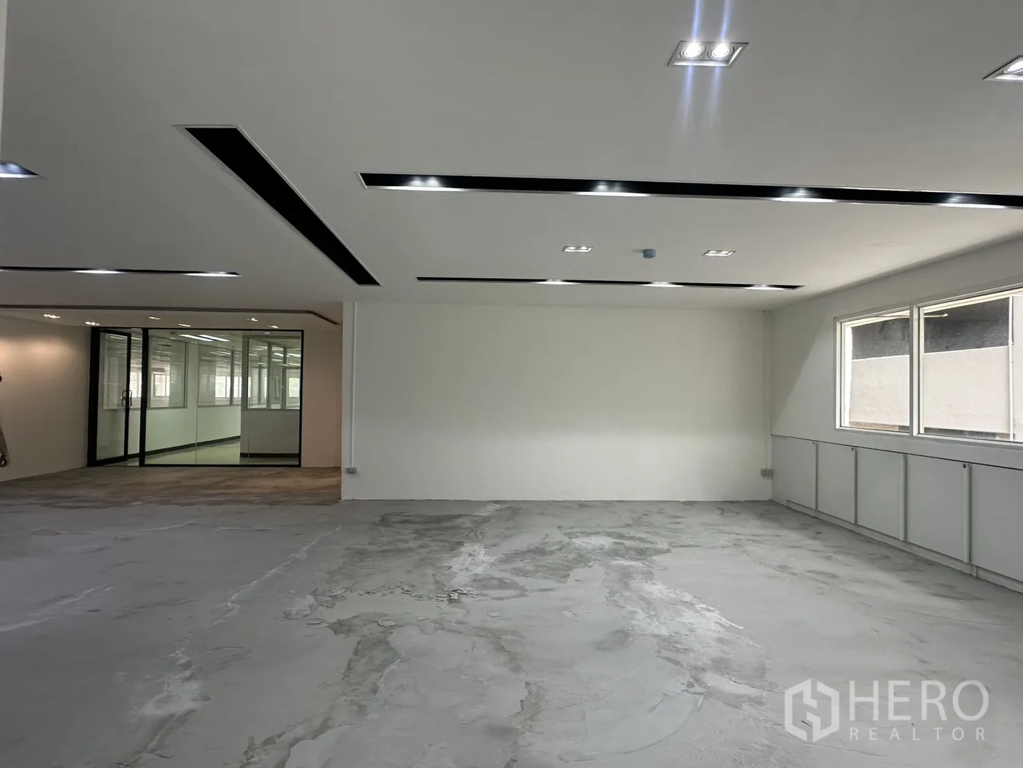 Office Space for rent in Pathum Wan, Bangkok - Spacious area with glass meeting room on the left and bright windows on the right.
