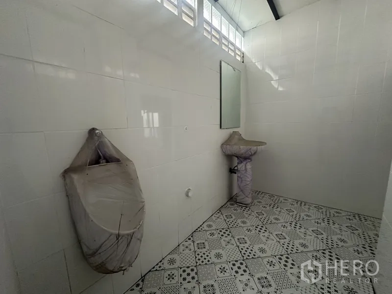 Home Office for rent or sale in Bang Na, Bangkok - Additional restroom with patterned floor tiles and basins.