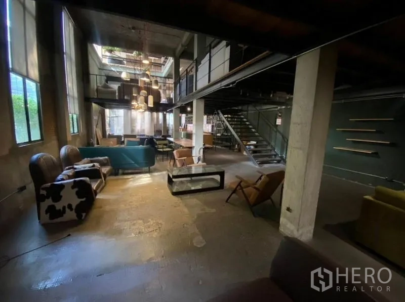 Retail Space for rent in Bang Na, Bangkok - Another view of the double-height showroom with sofas and mezzanine.