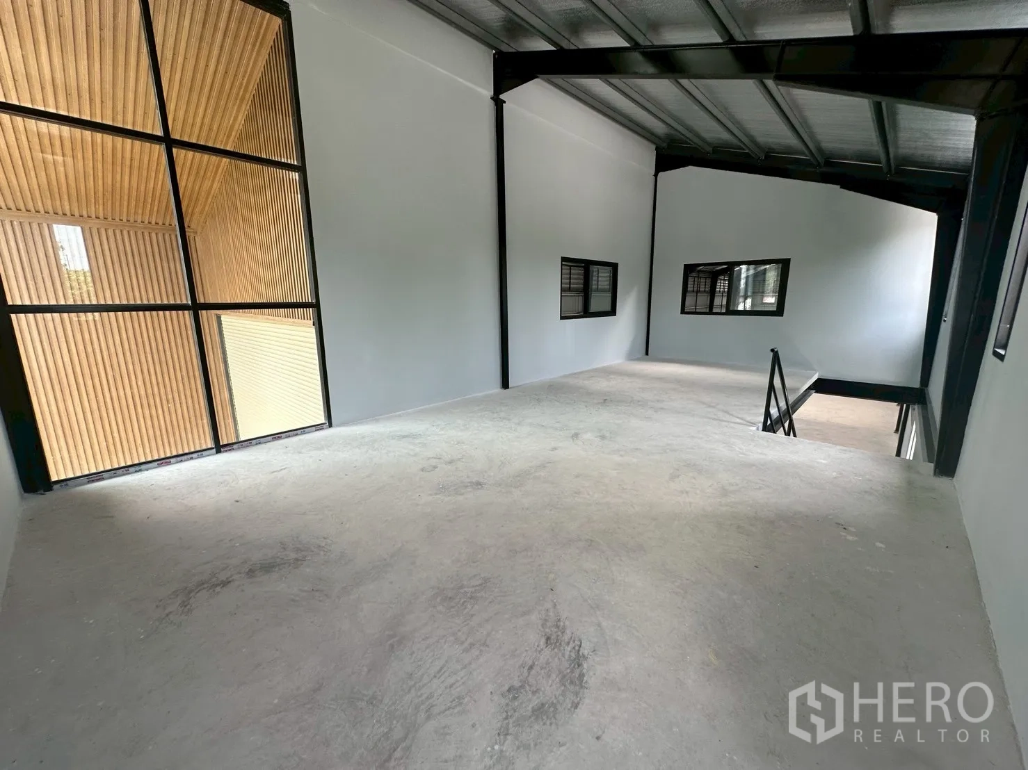 Warehouse for rent in Suan Luang, Bangkok - Mezzanine office area with floor-to-ceiling window facing the timber facade.