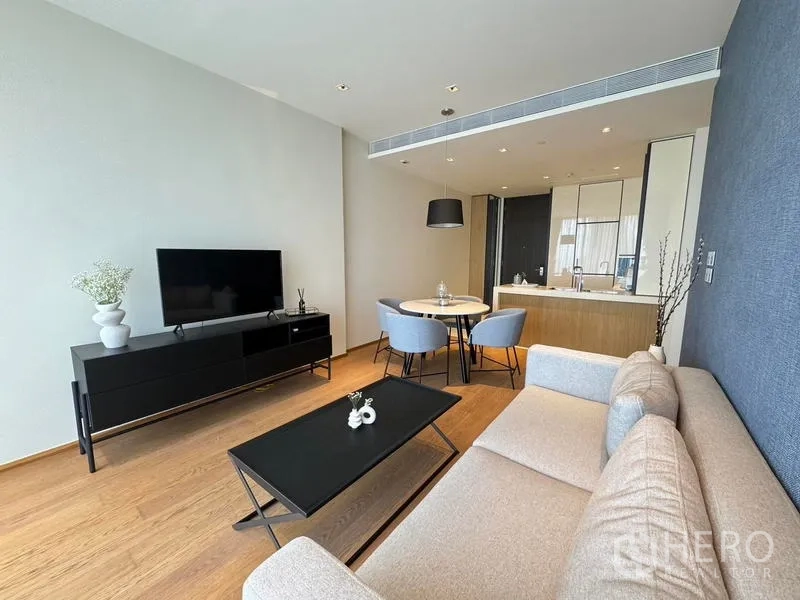 Condominium for rent - Living room with TV console, round dining set, and recessed lighting.