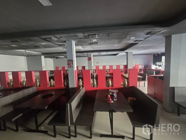 Retail Space for rent in Khlong Toei, Bangkok - Spacious dining-style layout with red partitions, multiple booths and recessed lighting, ideal for a restaurant or showroom.