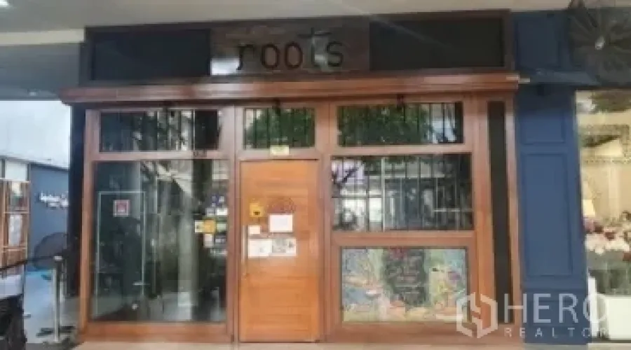 Retail Space for rent in Khlong Toei, Bangkok - Wood-framed storefront with glass windows and decorative signage.
