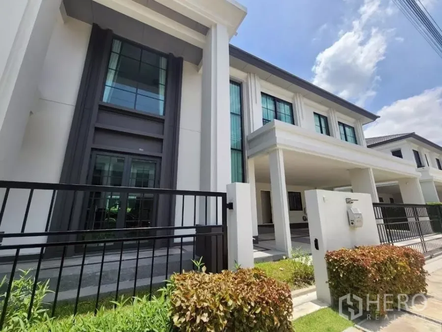 Detached House for rent in Bang Phli, Samut Prakan - Modern two-storey detached house exterior with tall columns, front gate and driveway.