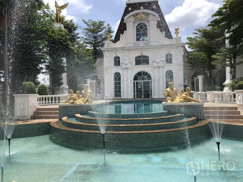 Townhouse for rent in Bang Kapi, Bangkok - Community clubhouse with ornate facade, tiered fountain and poolside statues.