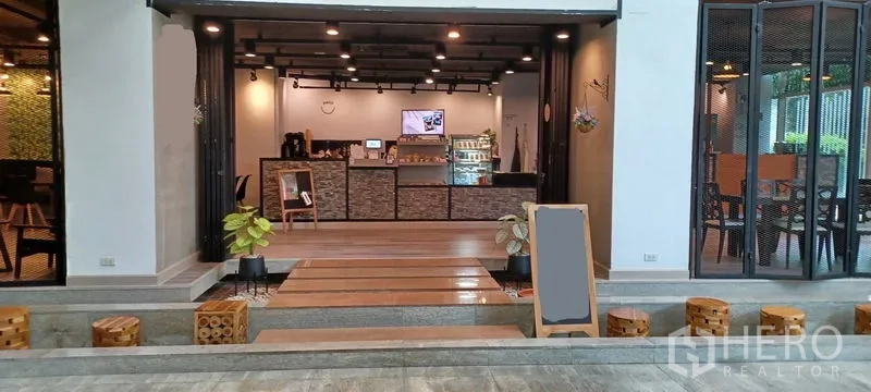 Retail Space for rent in Khlong Toei, Bangkok - Retail space interior with service counter, display fridge, wooden steps, and cube seating blocks.