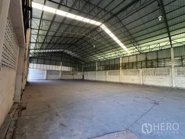 Warehouse for rent in Wang Noi, Phra Nakhon Si Ayutthaya - Empty warehouse hall highlighting high-clearance roof, skylight strips and ventilation block walls.