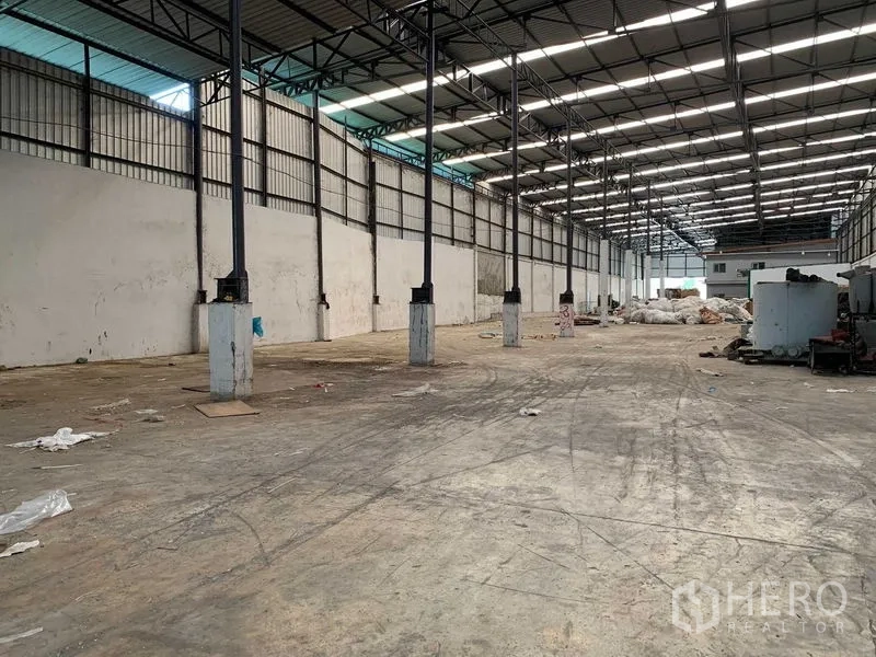 Factory for rent in Nakhon Pathom - Large warehouse interior with high roof, skylight panels, and wide open concrete floor.