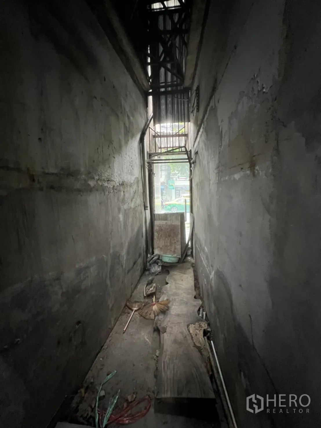 Shophouse for rent in Watthana, Bangkok - Interior metal staircase with handrail beneath a corrugated roof.