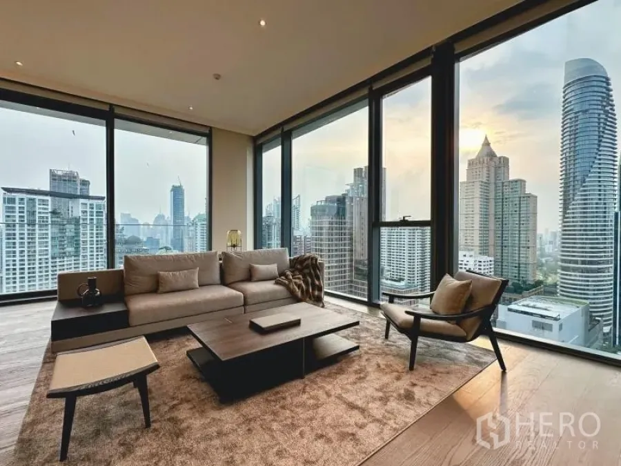 Condominium for rent or sale - Corner living room with full-height windows and sweeping skyline panorama.